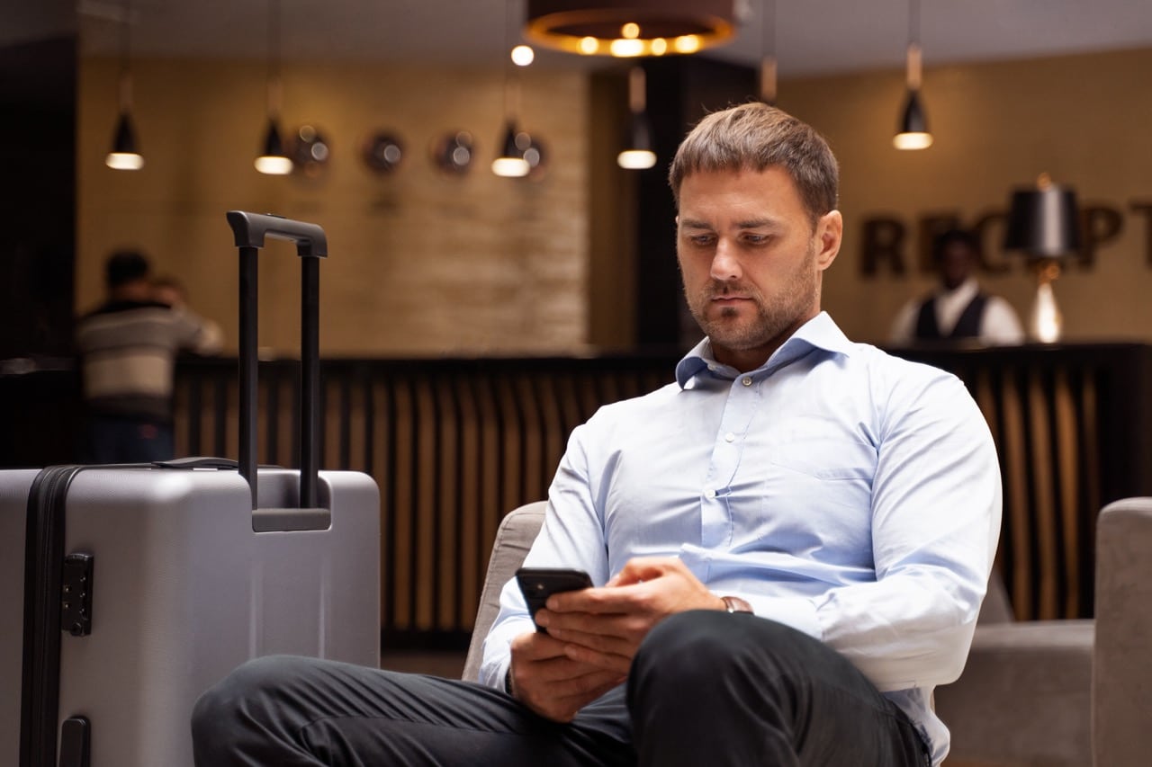 medium-shot-man-holding-smartphone